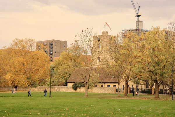 Autumn park with historic buildings and construction