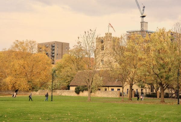 Autumn park with historic buildings and construction