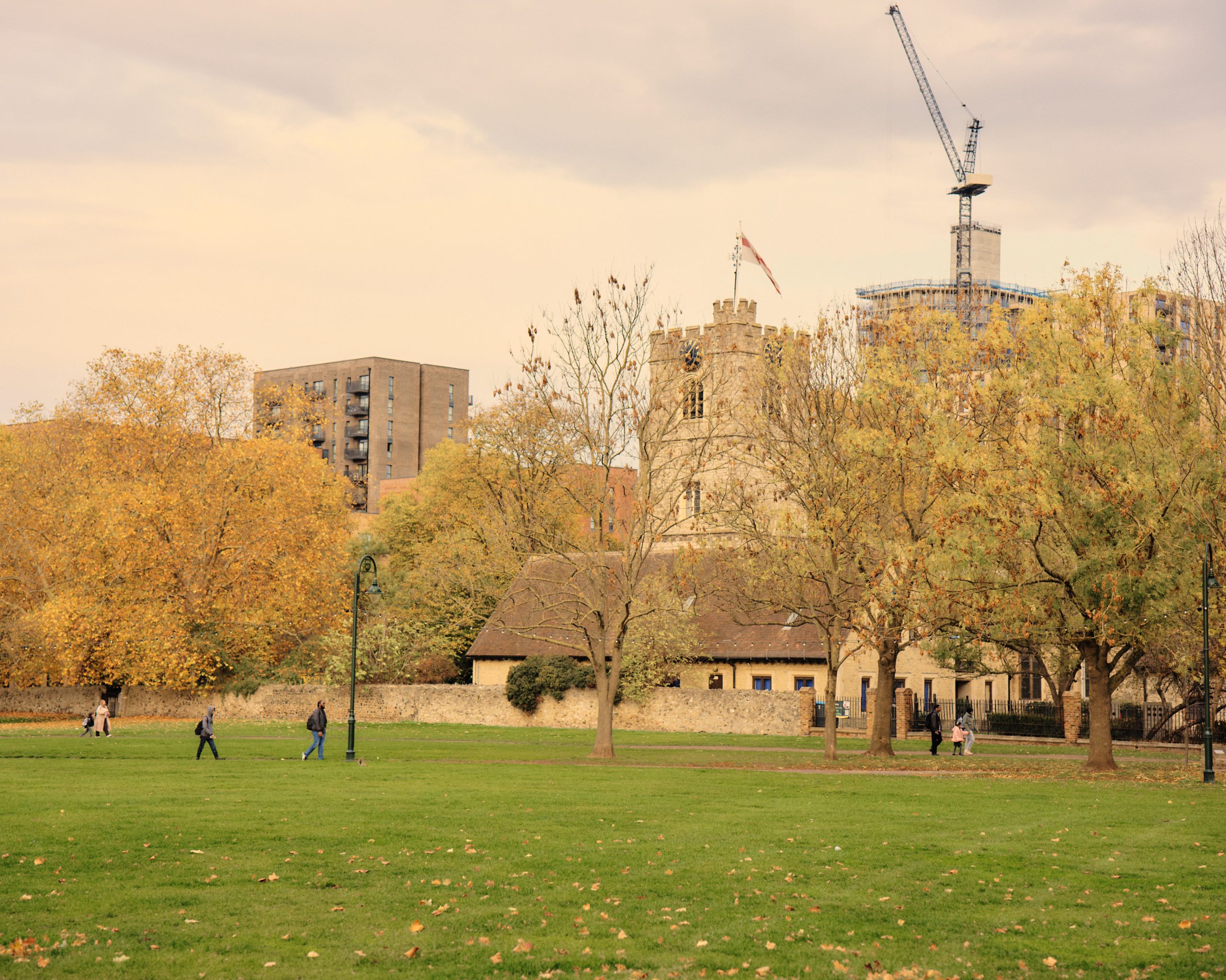 Autumn park with historic buildings and construction